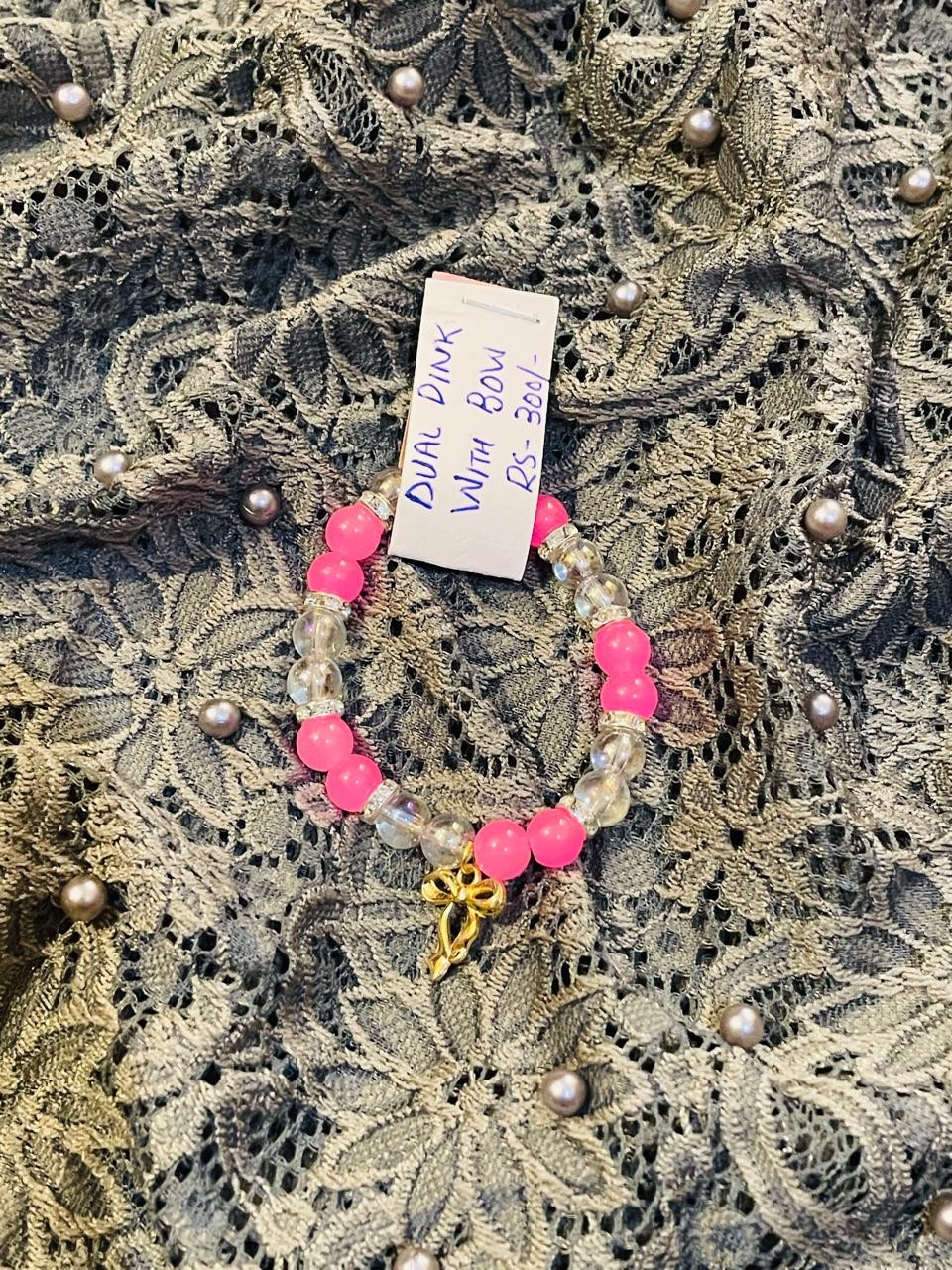 Pink bracelet with trendy bow charm